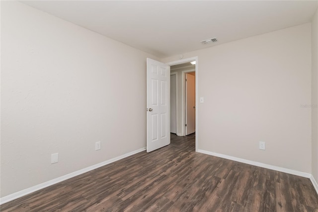 6426 Eden Ln, Tampa, FL 33634 - empty room featuring dark wood-style floors and baseboards