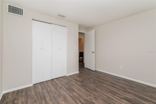 6426 Eden Ln, Tampa, FL 33634 - unfurnished bedroom with wood finished floors, baseboards, and a closet