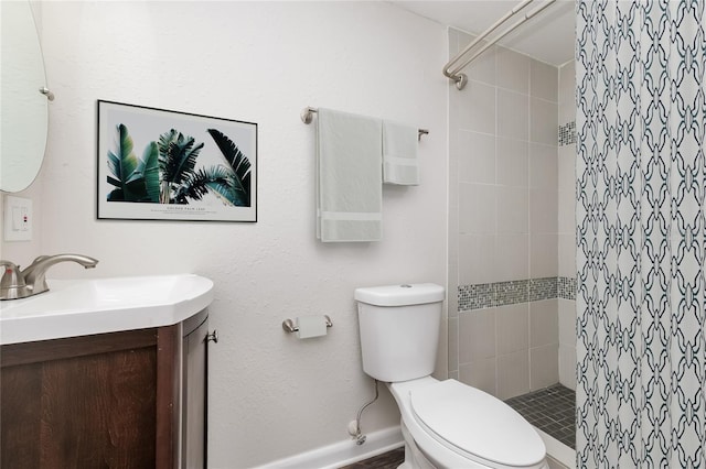 6426 Eden Ln, Tampa, FL 33634 - bathroom featuring vanity, tiled shower, toilet, and baseboards