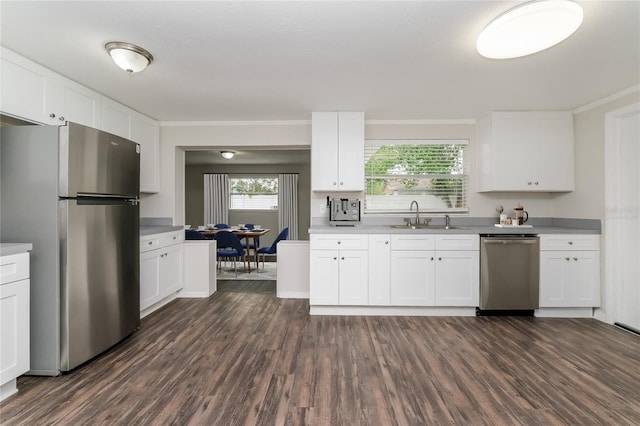 6426 Eden Ln, Tampa, FL 33634 - kitchen with appliances with stainless steel finishes, a sink, dark wood finished floors, white cabinetry, and light countertops