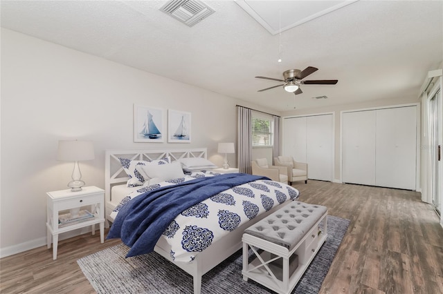 6426 Eden Ln, Tampa, FL 33634 - bedroom featuring wood finished floors, attic access, two closets, ceiling fan, and baseboards