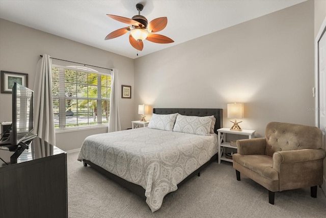 bedroom with light carpet, baseboards, and a ceiling fan