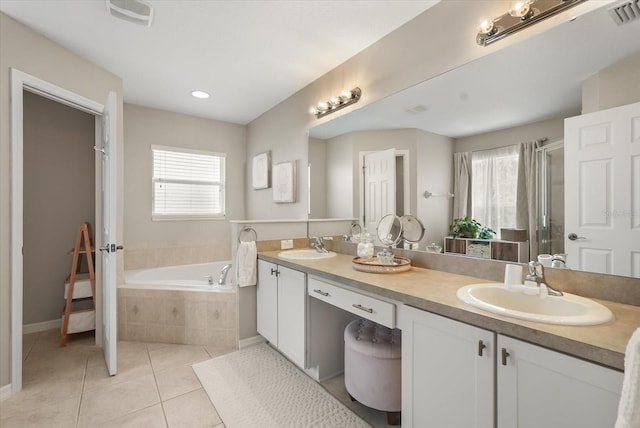 bathroom featuring tile patterned floors, a garden tub, a stall shower, double vanity, and baseboards