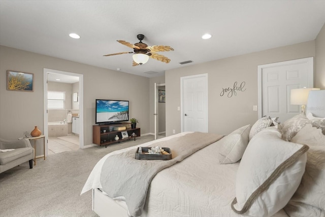 bedroom with light colored carpet, recessed lighting, a ceiling fan, connected bathroom, and baseboards