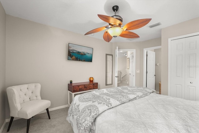 carpeted bedroom featuring a closet, baseboards, and a ceiling fan