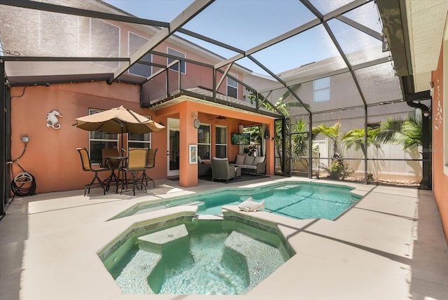 view of pool with a patio area, outdoor lounge area, a pool with connected hot tub, a ceiling fan, and glass enclosure