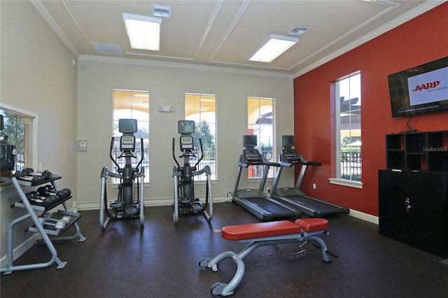 exercise room with crown molding and baseboards