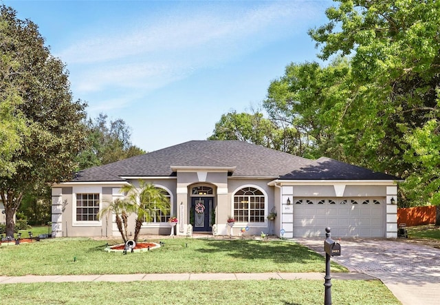 3451 Players Point Loop, Apopka, FL 32712 - single story home featuring stucco siding, an attached garage, driveway, and a shingled roof