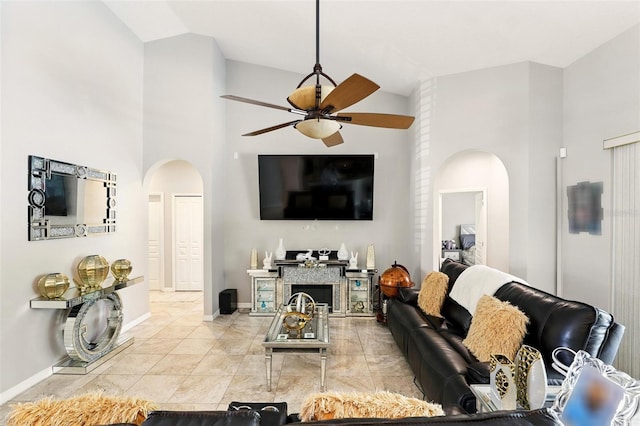 3451 Players Point Loop, Apopka, FL 32712 - living room with arched walkways, a ceiling fan, high vaulted ceiling, and baseboards