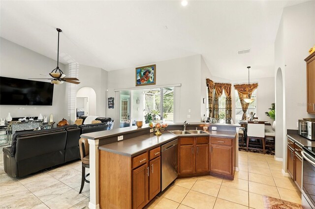 3451 Players Point Loop, Apopka, FL 32712 - kitchen with arched walkways, a sink, appliances with stainless steel finishes, ceiling fan, and brown cabinetry