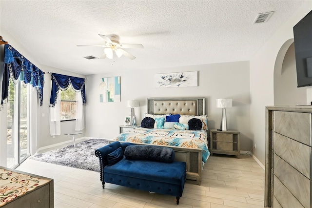 3451 Players Point Loop, Apopka, FL 32712 - bedroom featuring access to outside, light wood-style floors, a textured ceiling, baseboards, and a ceiling fan