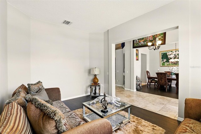 3451 Players Point Loop, Apopka, FL 32712 - living room with a chandelier, wood finished floors, and baseboards