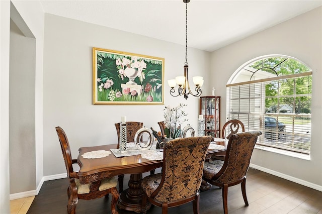 3451 Players Point Loop, Apopka, FL 32712 - dining room featuring a chandelier, baseboards, vaulted ceiling, and wood finished floors