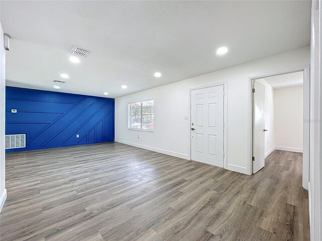 1307 Jean Ct, Eustis, FL 32726 - unfurnished living room featuring wood finished floors, baseboards, and recessed lighting