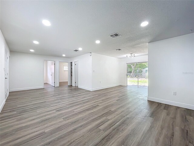 1307 Jean Ct, Eustis, FL 32726 - spare room featuring recessed lighting, wood finished floors, baseboards, and a textured ceiling