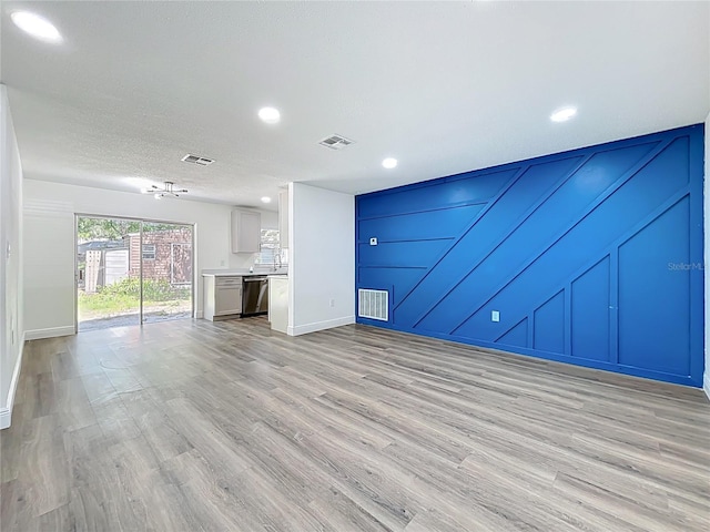 1307 Jean Ct, Eustis, FL 32726 - unfurnished living room featuring a decorative wall, light wood-style flooring, recessed lighting, and baseboards