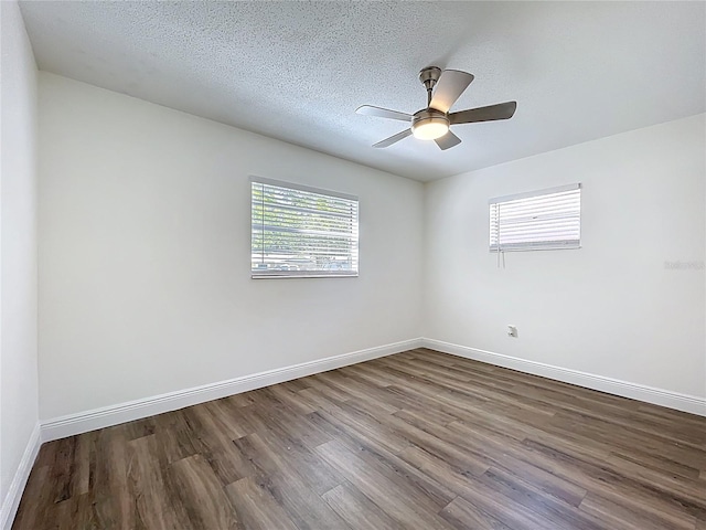 1307 Jean Ct, Eustis, FL 32726 - unfurnished room with dark wood-style flooring, baseboards, a textured ceiling, and ceiling fan