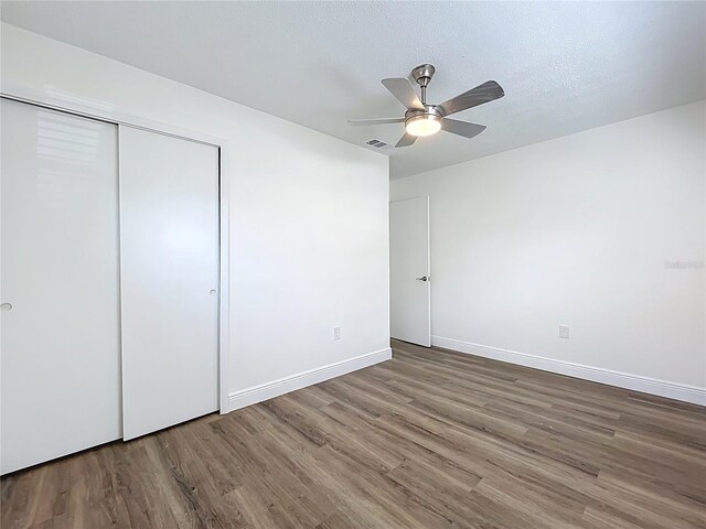 1307 Jean Ct, Eustis, FL 32726 - unfurnished bedroom featuring wood finished floors, a closet, baseboards, and ceiling fan