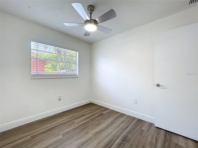 1307 Jean Ct, Eustis, FL 32726 - empty room with wood finished floors, baseboards, and a textured ceiling