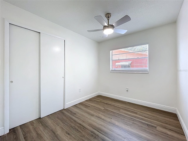 1307 Jean Ct, Eustis, FL 32726 - unfurnished bedroom featuring wood finished floors, a closet, baseboards, a textured ceiling, and a ceiling fan