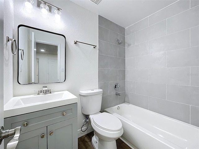 1307 Jean Ct, Eustis, FL 32726 - full bathroom featuring wood finished floors, washtub / shower combination, toilet, vanity, and baseboards