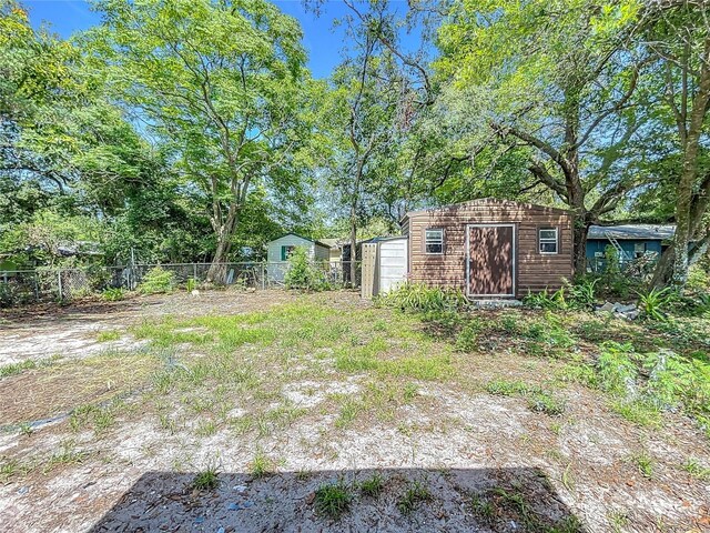 1307 Jean Ct, Eustis, FL 32726 - view of yard featuring fence, a storage shed, and an outdoor structure