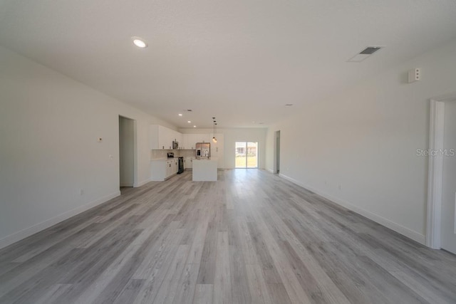 13419 SW 77th Ave, Ocala, FL 34473 - unfurnished living room featuring light wood-style floors, recessed lighting, and baseboards