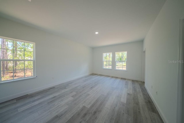 13419 SW 77th Ave, Ocala, FL 34473 - empty room with wood finished floors, baseboards, and recessed lighting