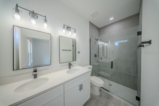 13419 SW 77th Ave, Ocala, FL 34473 - full bathroom with toilet, a stall shower, double vanity, and wood finished floors