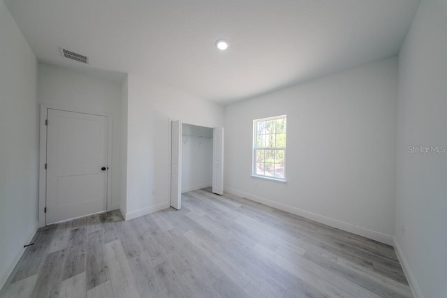 13419 SW 77th Ave, Ocala, FL 34473 - unfurnished bedroom with wood finished floors, baseboards, a closet, and recessed lighting