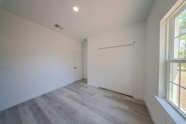 13419 SW 77th Ave, Ocala, FL 34473 - unfurnished bedroom with multiple windows, wood finished floors, recessed lighting, and a closet