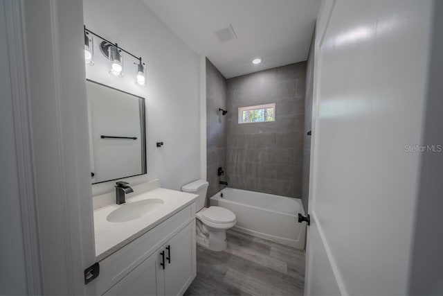 13419 SW 77th Ave, Ocala, FL 34473 - full bathroom with wood finished floors, vanity, toilet, and shower / washtub combination
