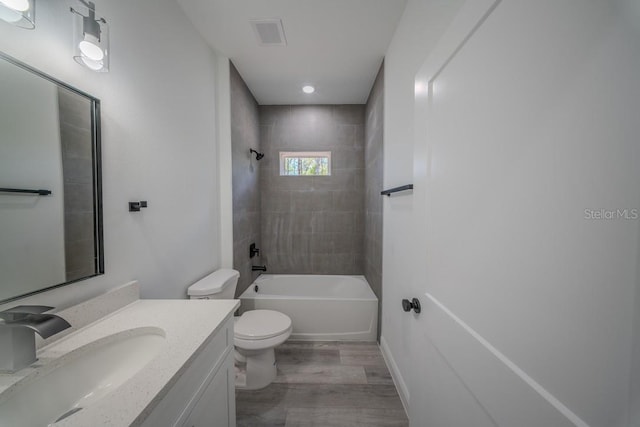 13419 SW 77th Ave, Ocala, FL 34473 - full bath featuring wood finished floors, toilet, vanity,  shower combination, and baseboards