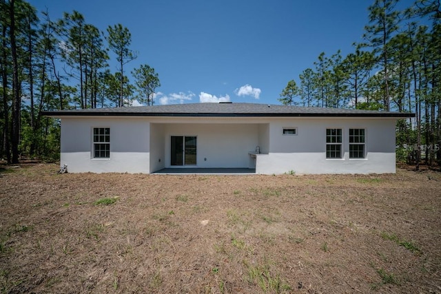 13419 SW 77th Ave, Ocala, FL 34473 - rear view of property with stucco siding and a patio area