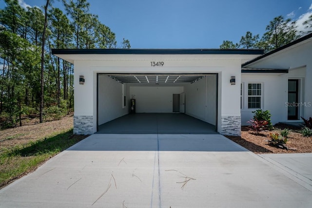 13419 SW 77th Ave, Ocala, FL 34473 - garage featuring concrete driveway