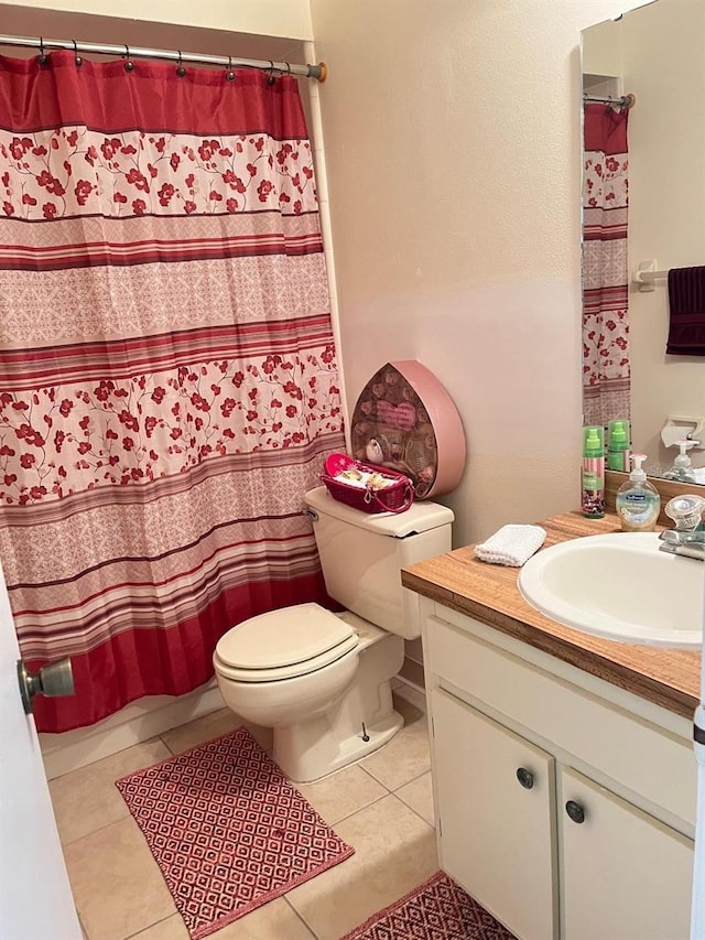 bathroom with toilet, vanity, tile patterned flooring, and a shower with shower curtain