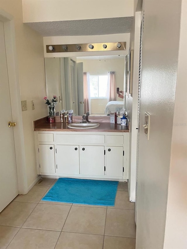 bathroom with vanity and tile patterned flooring