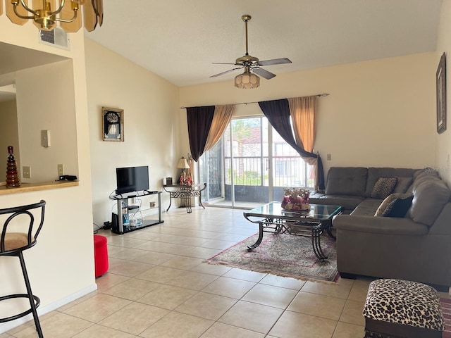 living room featuring vaulted ceiling, light tile patterned flooring, and ceiling fan