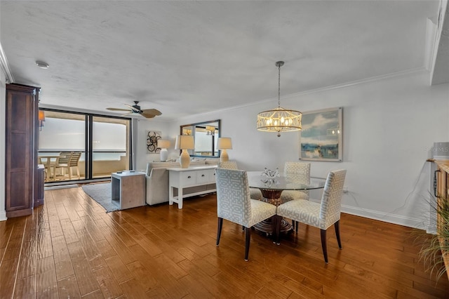 5275 S Atlantic Ave Unit 506, New Smyrna Beach, FL 32169 - dining room featuring dark wood finished floors, a chandelier, crown molding, a ceiling fan, and baseboards