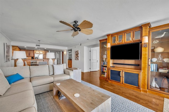 5275 S Atlantic Ave Unit 506, New Smyrna Beach, FL 32169 - living room featuring ornamental molding, ceiling fan, and wood finished floors