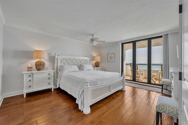 5275 S Atlantic Ave Unit 506, New Smyrna Beach, FL 32169 - bedroom featuring access to exterior, wood-type flooring, ornamental molding, baseboards, and a ceiling fan