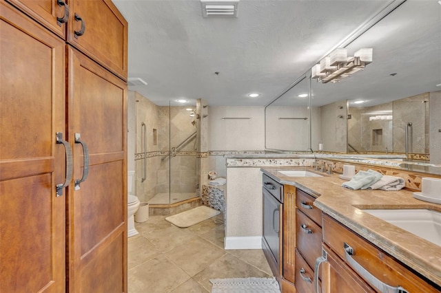5275 S Atlantic Ave Unit 506, New Smyrna Beach, FL 32169 - full bath featuring toilet, a stall shower, tile patterned floors, double vanity, and recessed lighting