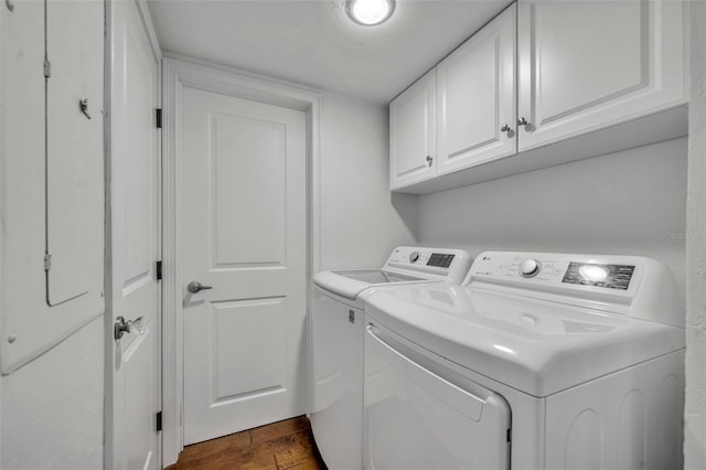 5275 S Atlantic Ave Unit 506, New Smyrna Beach, FL 32169 - washroom with washer and dryer, dark wood finished floors, and cabinet space