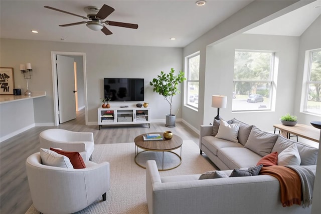 4704 Walden Cir Unit 21, Orlando, FL 32811 - living room featuring wood finished floors, a ceiling fan, baseboards, and recessed lighting