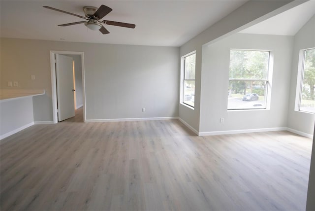 4704 Walden Cir Unit 21, Orlando, FL 32811 - unfurnished room with light wood-type flooring, a ceiling fan, and baseboards