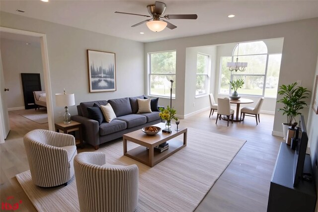 4704 Walden Cir Unit 21, Orlando, FL 32811 - living room featuring baseboards, a ceiling fan, recessed lighting, and light wood-style flooring