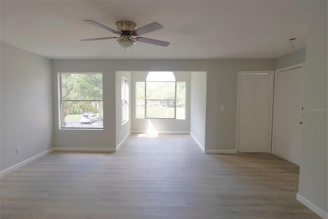 4704 Walden Cir Unit 21, Orlando, FL 32811 - empty room featuring light wood-style flooring, a ceiling fan, and baseboards