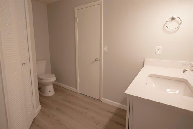 4704 Walden Cir Unit 21, Orlando, FL 32811 - bathroom featuring a closet, wood finished floors, toilet, and vanity