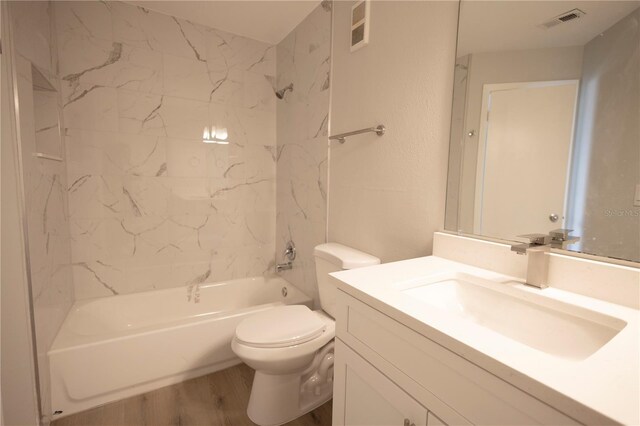 4704 Walden Cir Unit 21, Orlando, FL 32811 - full bath with wood finished floors, toilet, washtub / shower combination, and vanity