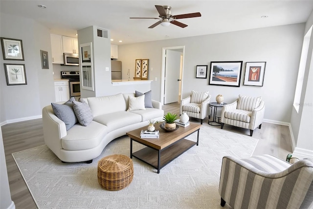 4704 Walden Cir Unit 21, Orlando, FL 32811 - living area featuring light wood finished floors, baseboards, a ceiling fan, and recessed lighting